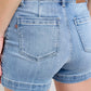 Back view of Judy Blue Mid Rise light-wash denim shorts with brown leather patches