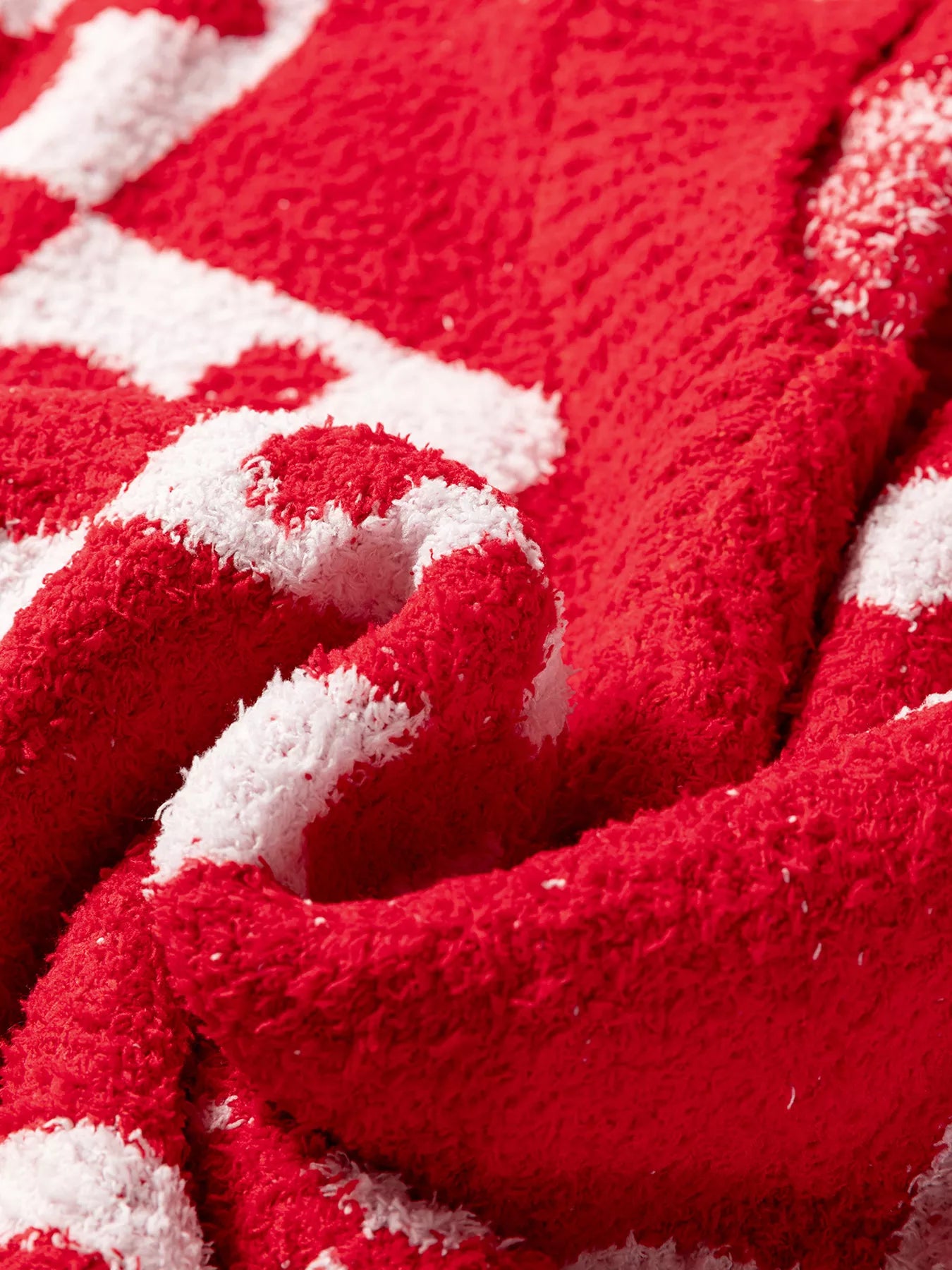 Red and white striped plush towel with soft textured surface