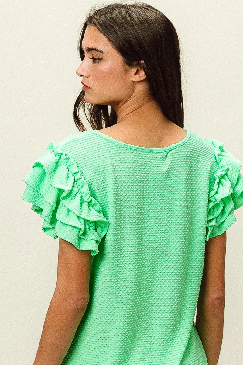 BiBi Birdseye Texture Layered Ruffle Top in vibrant mint green waffle-knit fabric
