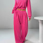 Bright pink one-shoulder cropped sweatshirt with matching wide-leg joggers