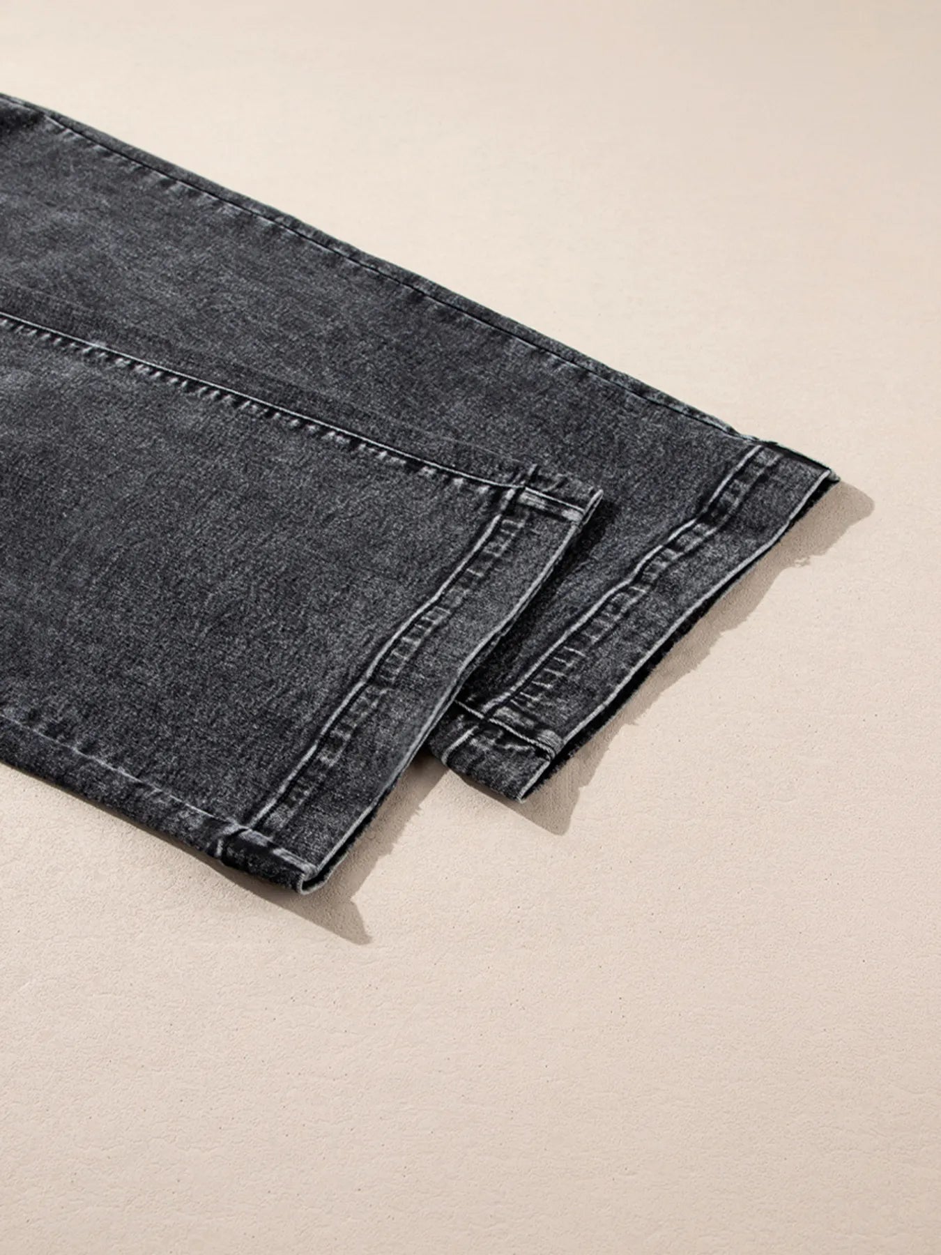 High-waisted wide leg dark gray denim jeans with faded wash and white stitching