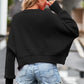 Black cropped round neck drop shoulder long sleeve sweater with ribbed cuffs