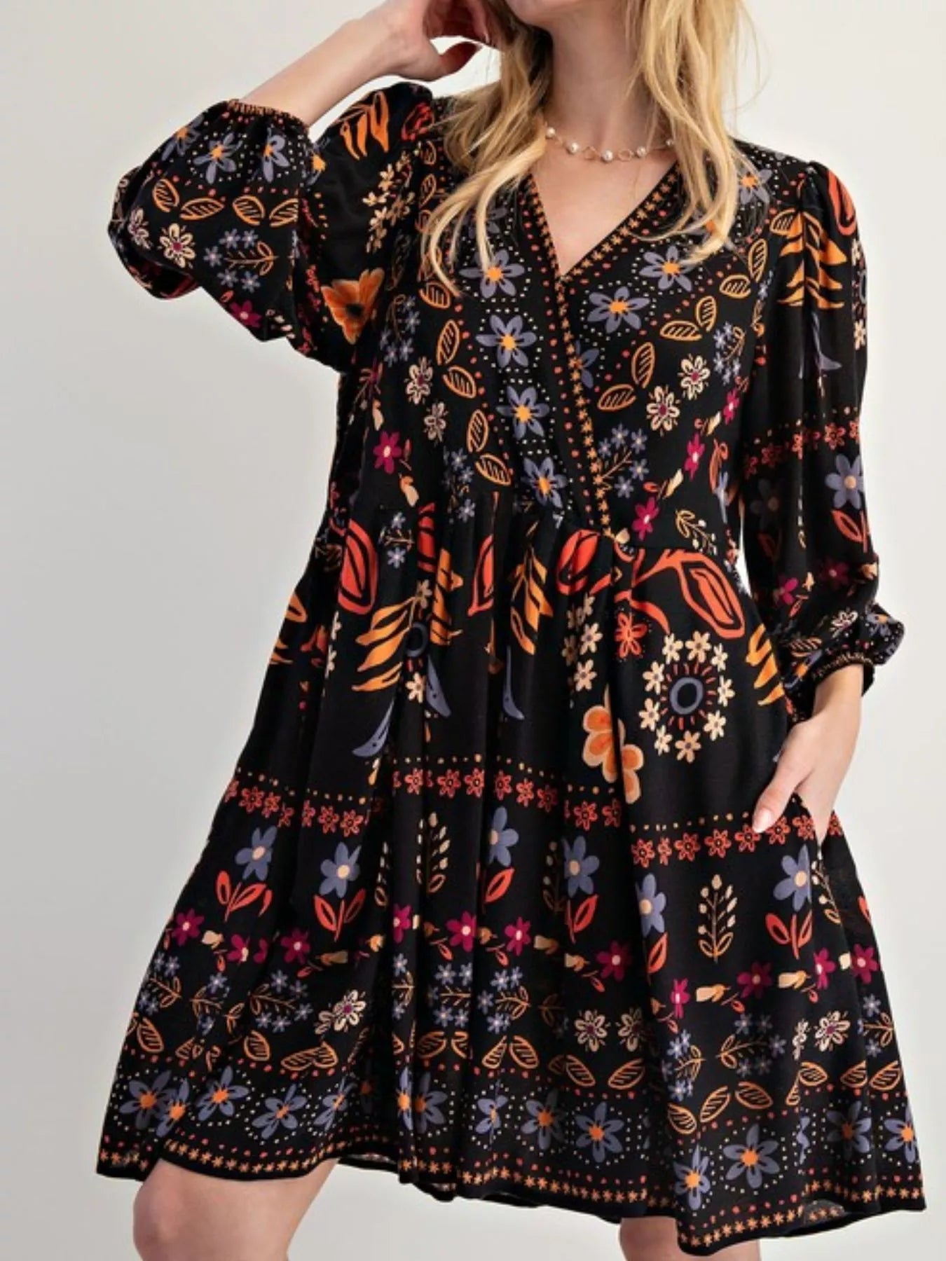 Bohemian black floral print mini dress with long puffed sleeves and v-neckline