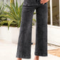 High-waisted dark gray wide-leg denim jeans with faded wash and rolled cuffs