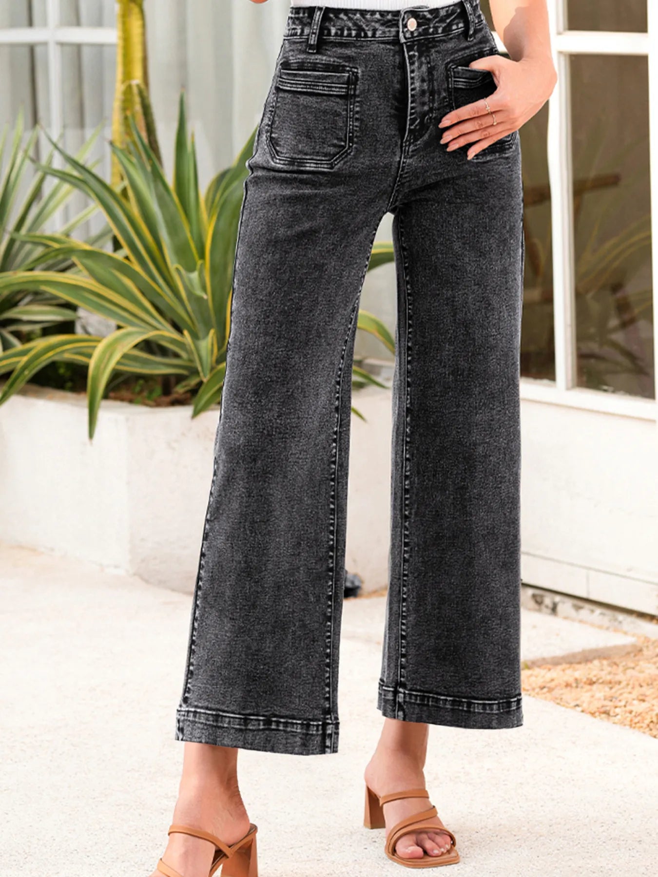 High-waisted dark gray wide-leg denim jeans with faded wash and rolled cuffs