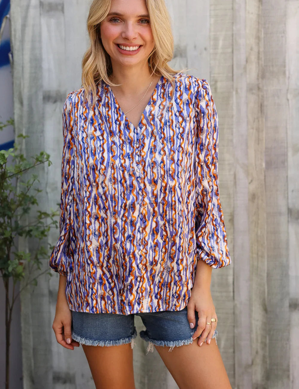 On A Wild Streak V Neck Fabric Button Detail Blouse | Daverri Fashions