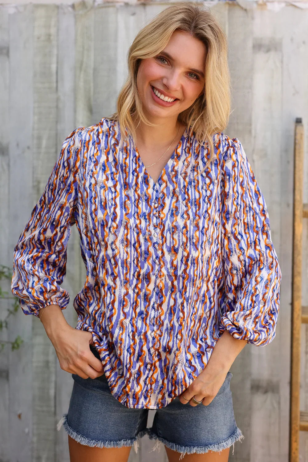 On A Wild Streak V Neck Fabric Button Detail Blouse | Daverri Fashions