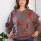 Cozy taupe Sequins and Spells Spooky Pullover with orange sequin figures