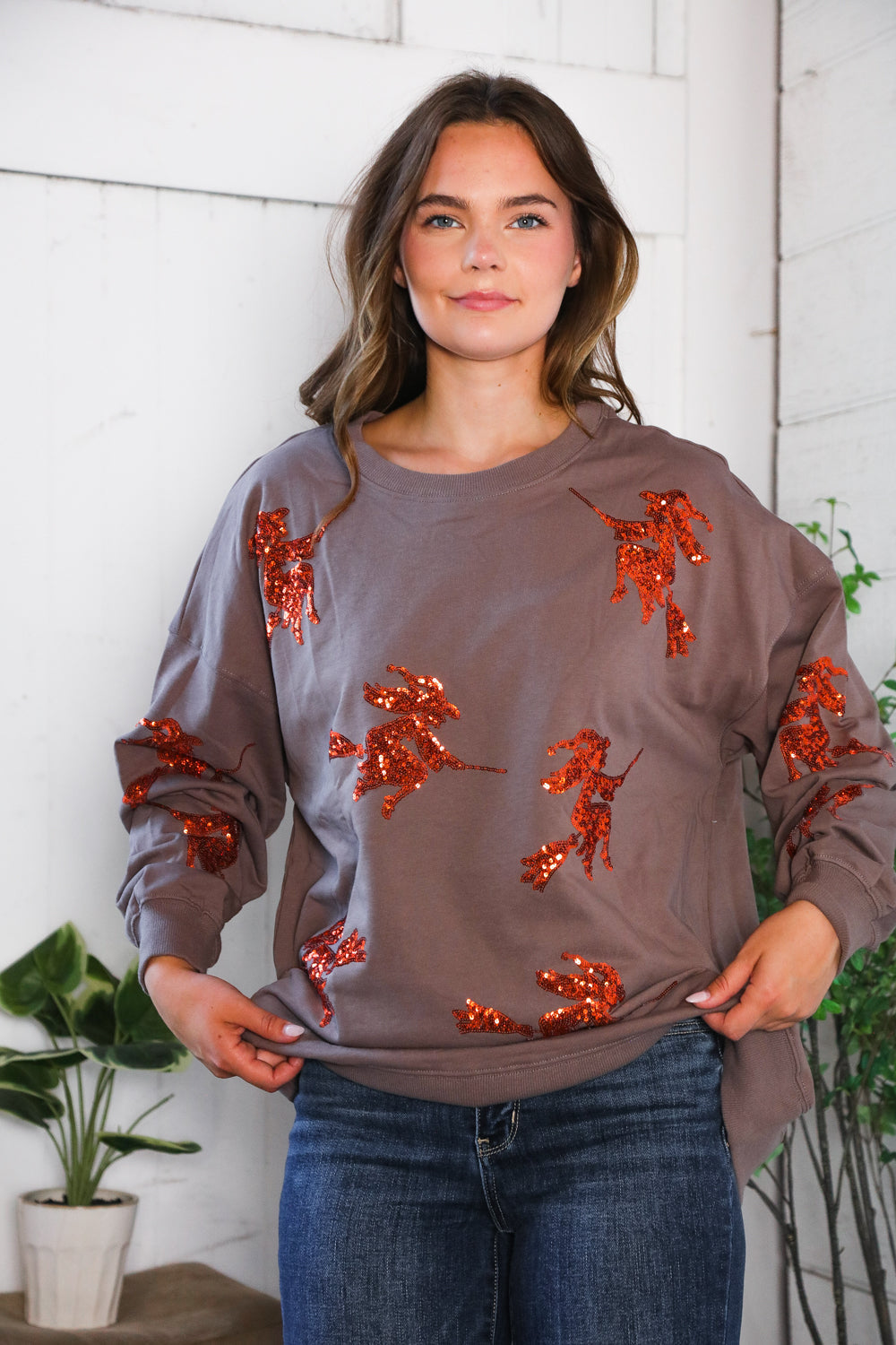 Cozy taupe Sequins and Spells Spooky Pullover with orange sequin figures