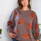Cozy taupe Sequins and Spells Spooky Pullover with orange sequin leaves