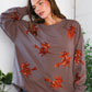 Taupe long-sleeved Sequins and Spells Spooky Pullover with orange sequin witches