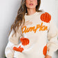 Cream-colored knit sweater with embroidered orange pumpkins and Pumpkin Patch Pullover text