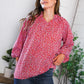 Vibrant Poppy Daydream floral woven blouse with red print, flowing silhouette and rolled-up sleeves