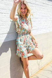 Get Whimsical Tropical Print Smocked Waist Neck Button Romper | Daverri Fashions
