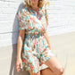 Get Whimsical Tropical Print Smocked Waist Neck Button Romper - DAVERRI FASHIONS