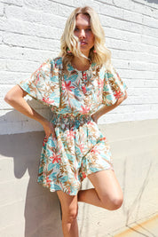 Get Whimsical Tropical Print Smocked Waist Neck Button Romper | Daverri Fashions