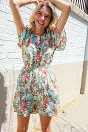 Get Whimsical Tropical Print Smocked Waist Neck Button Romper | Daverri Fashions