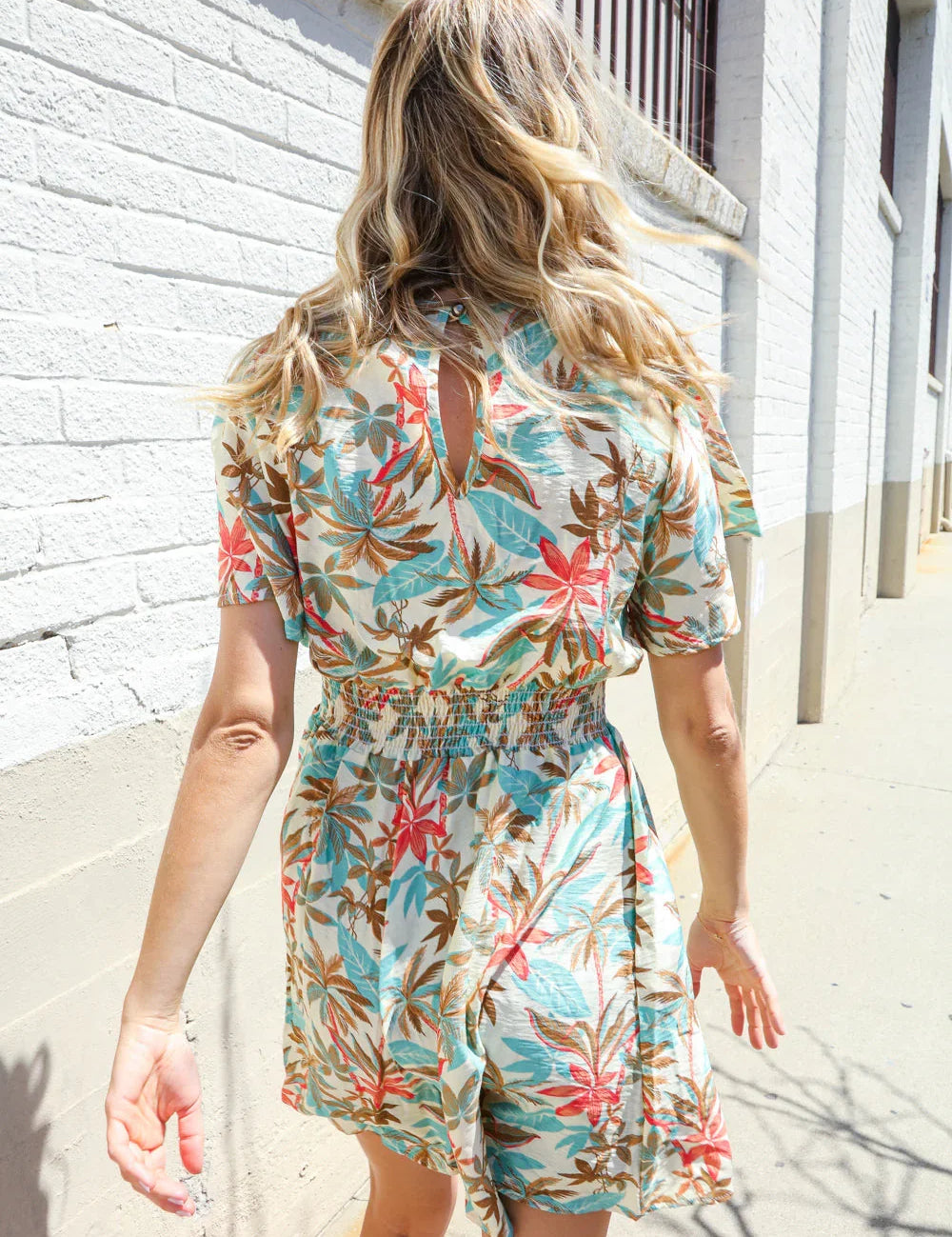 Get Whimsical Tropical Print Smocked Waist Neck Button Romper | Daverri Fashions