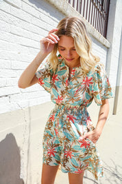 Get Whimsical Tropical Print Smocked Waist Neck Button Romper | Daverri Fashions