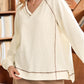 Beige exposed seam textured knit V-neck pullover sweater