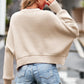 Beige cropped knit sweater with wide sleeves and ribbed cuffs