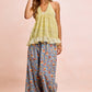 Woman in BiBi Floral Printed Drawstring Wide Pants, light green ruffled halter top