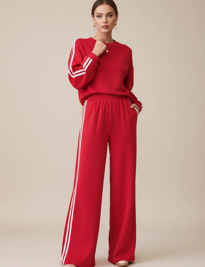 Red Adidas tracksuit set with white stripes and elastic waistband