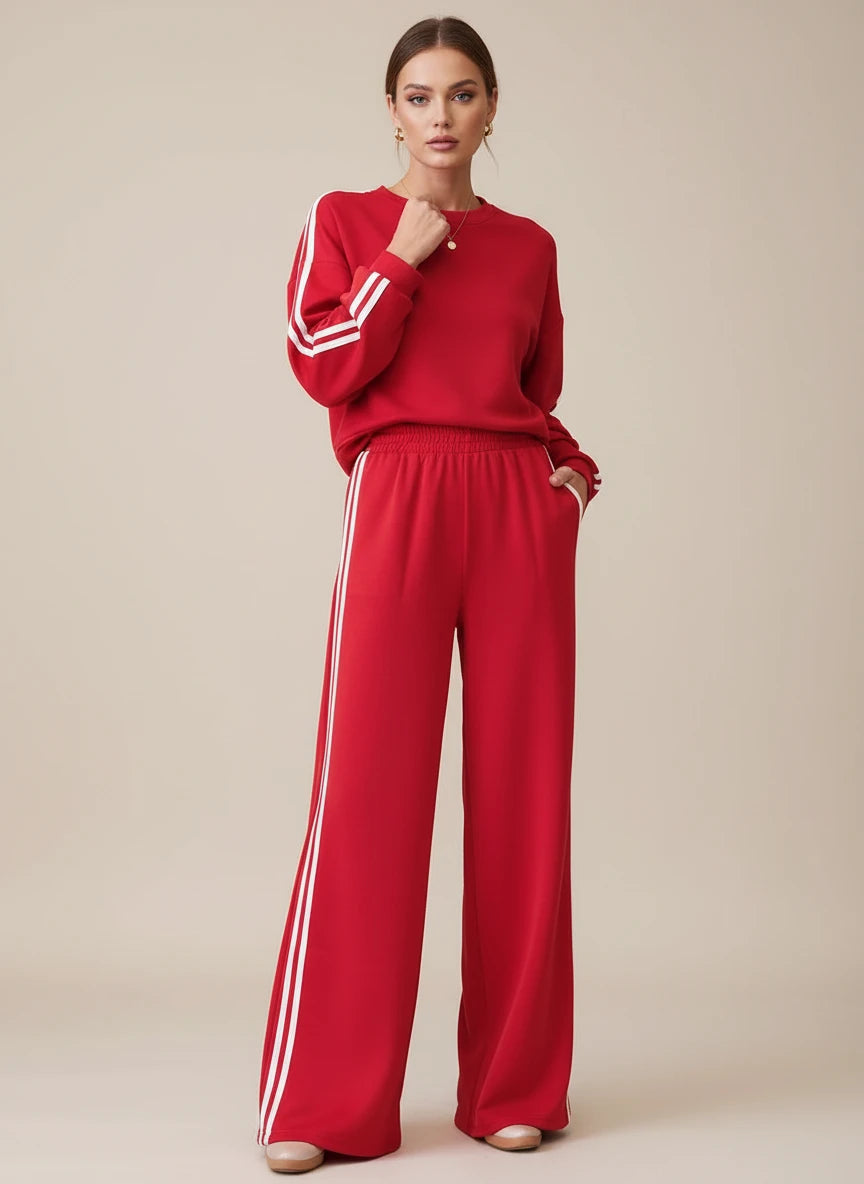 Red Adidas tracksuit set with white stripes and elastic waistband