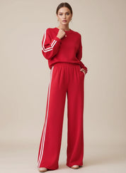 Red Adidas tracksuit set with white stripes and elastic waistband