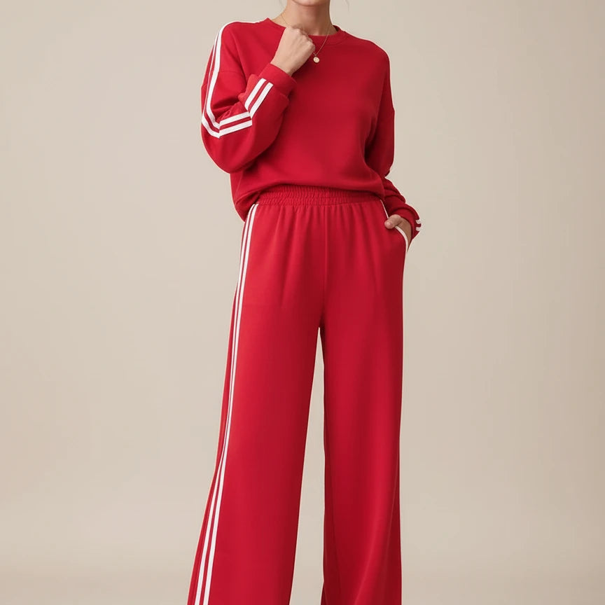 Red Adidas tracksuit set with white stripes and elastic waistband