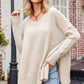Beige v-neck oversized knit sweater with ribbed cuffs and hem