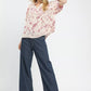 Woman in Umgee Mixed Print Puff Sleeve Top with navy wide-leg pants