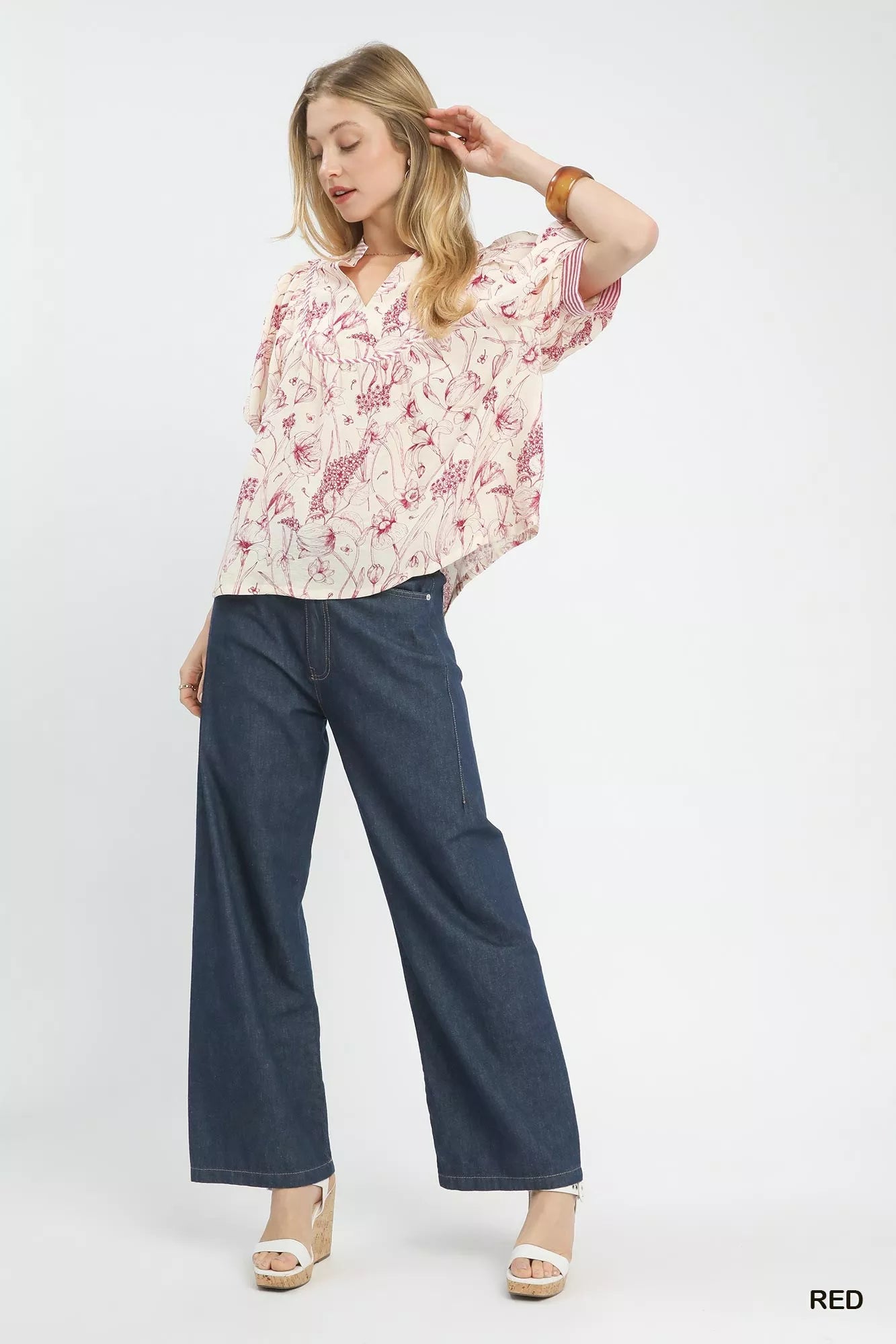 Woman in Umgee Mixed Print Puff Sleeve Top with navy wide-leg pants