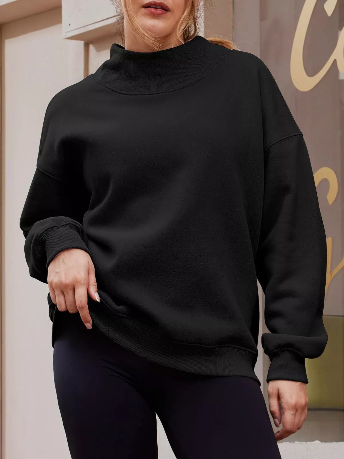 Black oversized mock neck sweatshirt with ribbed cuffs and hem