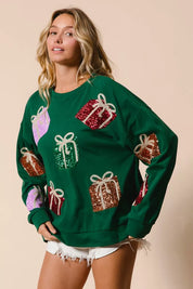 Green sequined gift box sweatshirt with white bows and pastel accents