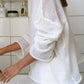 Boat neck dropped shoulder sweater in loose white knit with ruffled sleeves