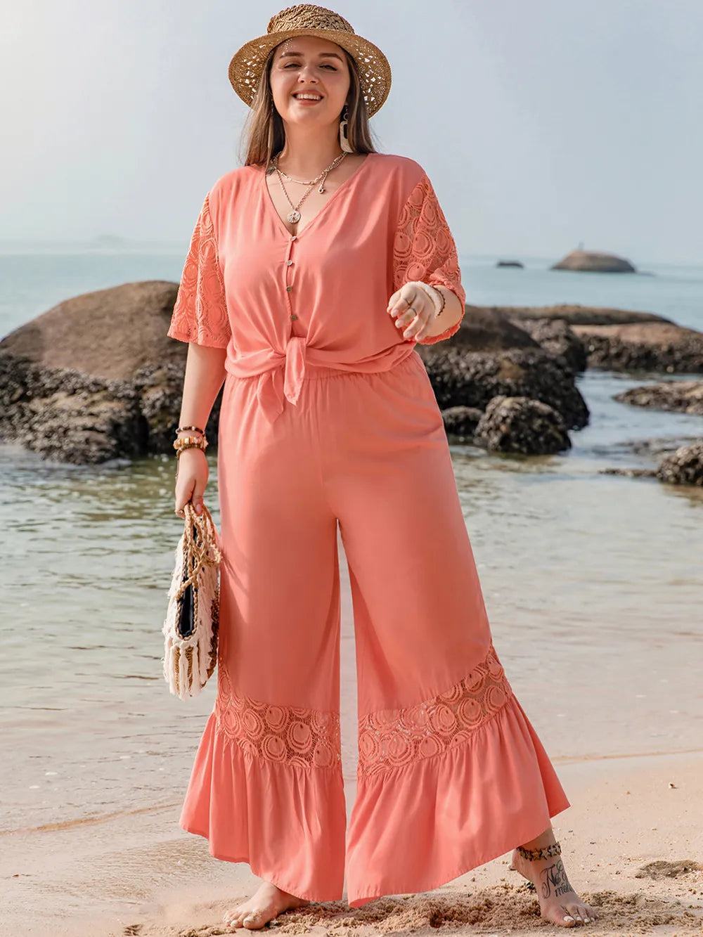 Coral plus size jumpsuit with lace sleeves, hem, tied waist
