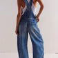 Wide strap wide leg denim overalls in faded distressed blue