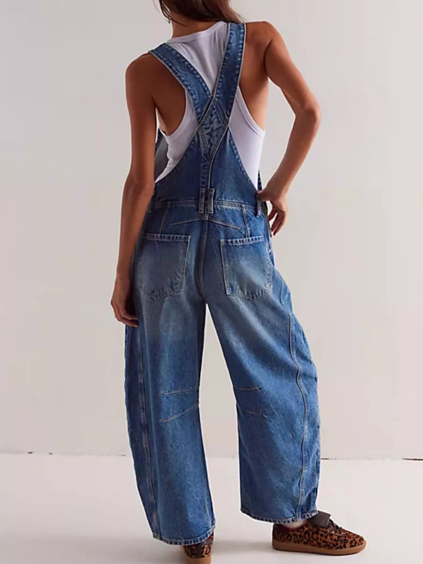 Wide strap wide leg denim overalls in faded distressed blue