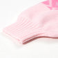 Pink ribbed knit sweater cuff with subtle geometric pattern