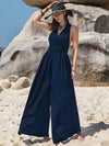 Navy blue Surplice Wide Leg Jumpsuit with halter neck, cinched waist, and free tie
