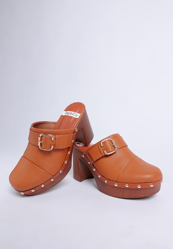 Tan leather studded clog mules with chunky wooden heel and gold buckle