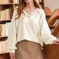 Cream-colored ribbed knit v-neck pullover with gray seam stitching