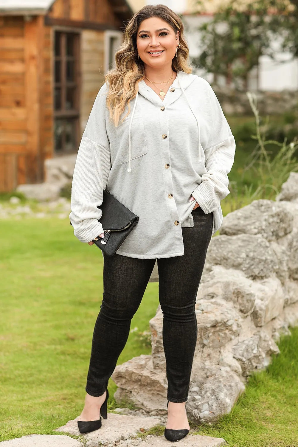 Plus size white button-up hoodie with black jeans and heels