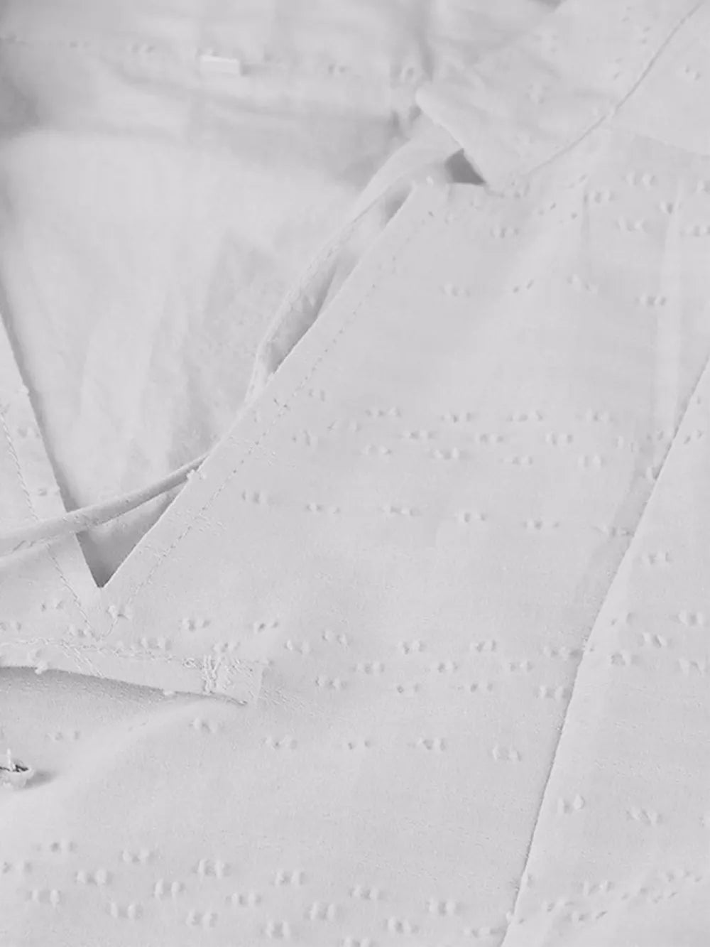 White eyelet blouse with lace detailing on full size tied mini dress