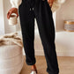 Daverri Fashions black corduroy tapered pants with drawstring waist and rolled cuffs