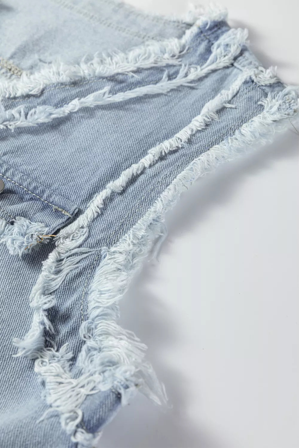 Light-wash frayed edge denim vest jacket with distressed shorts
