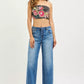 Black strapless crop top with pink red green floral embroidery on RISEN boyfriend jeans