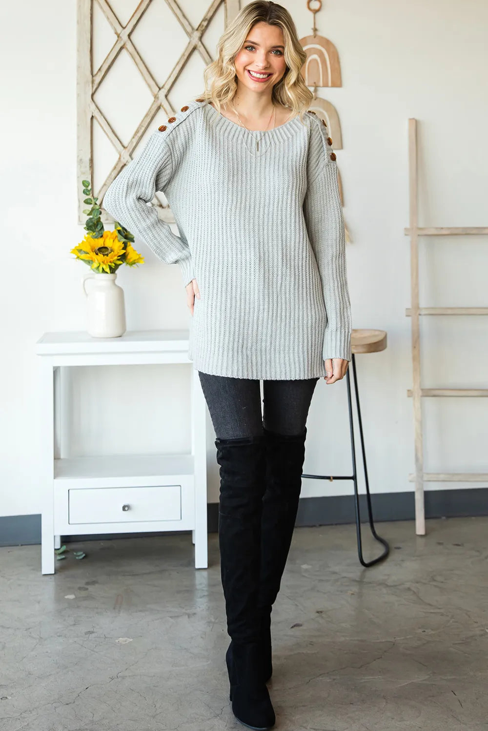 Grey ribbed knit boat neck sweater with shoulder buttons and side slits