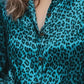 Teal leopard-print button-up long sleeve blouse with dark brown buttons